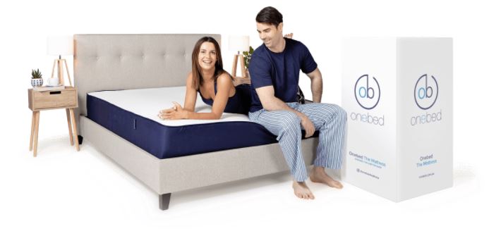 man and lady sitting on a onebed mattress